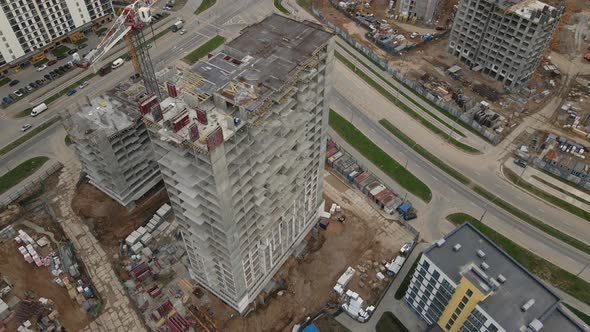 Flying Over A Construction Site In An Arc. Modern Urban Development. alt