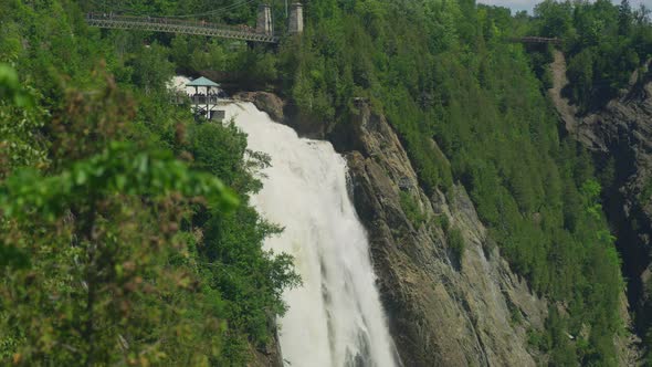 Montmorency Falls behind green branches