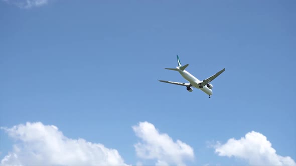 Airplane Flight and Landing in Sunny Day with Blue Sky