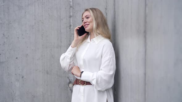 Smiling Woman Talking on Smartphone