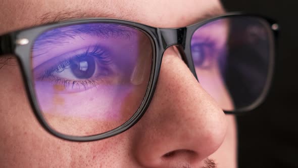 Focused Office Worker Wears Glasses for Reducing Eye Strain