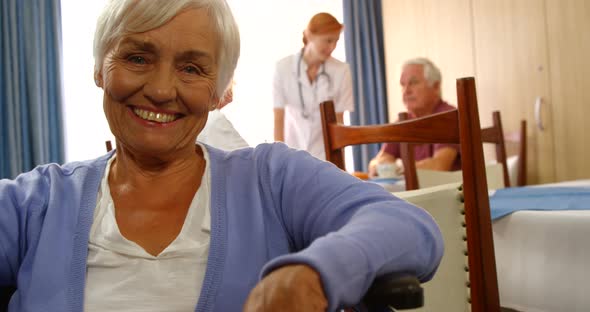 Portrait of happy senior woman on wheel chair