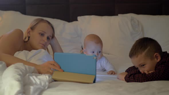 A mother and her kids having family time before bed