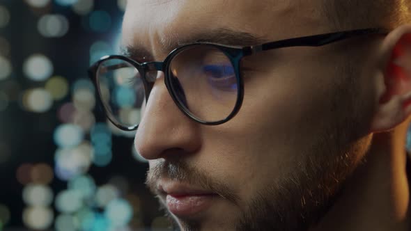 Close-up portrait of a young man working at the computer.