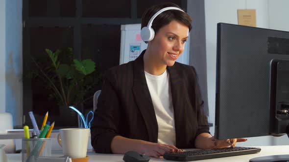 Businesswoman in Earphones with Computer at Office 62