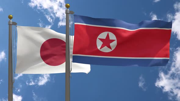 Japan Flag Vs North Korea Flag On Flagpole