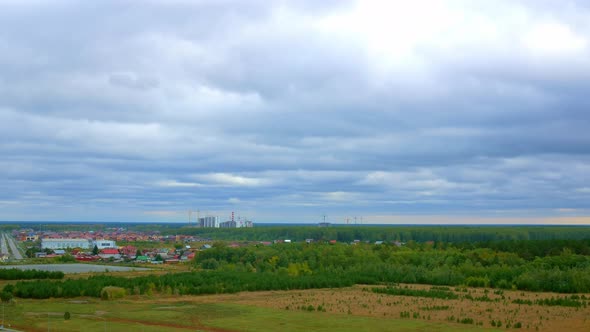 Timelapse From a Height to the Outskirts of the City with a Lot of Greenery and Forest