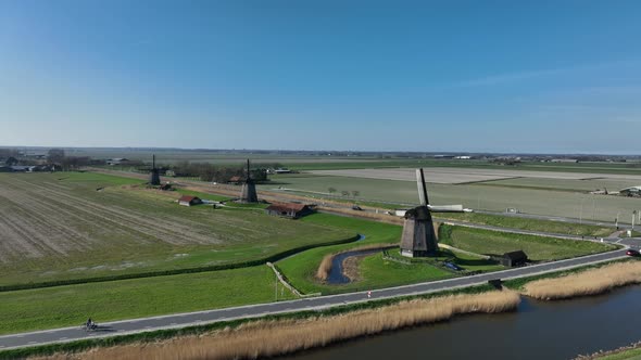 Historic Dutch Windmills in a Farm and Grass Field Landscape in The Netherlands Holland