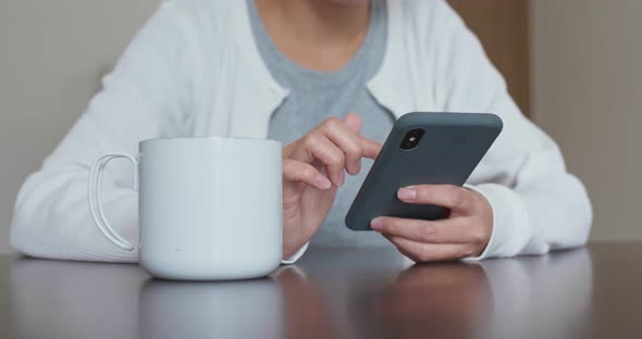 Woman use of cellphone at home