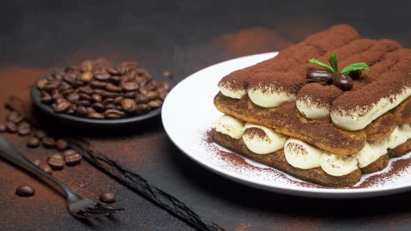 Classic Tiramisu Dessert on Ceramic Plate on Concrete Background