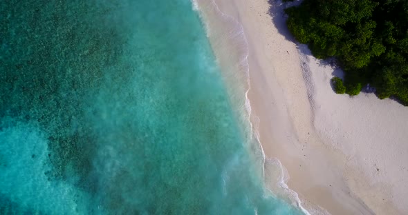 Luxury drone copy space shot of a white sandy paradise beach and blue ocean background in colorful