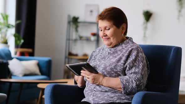 Old Woman Communicates Via Video Link with Family and Friends From Home