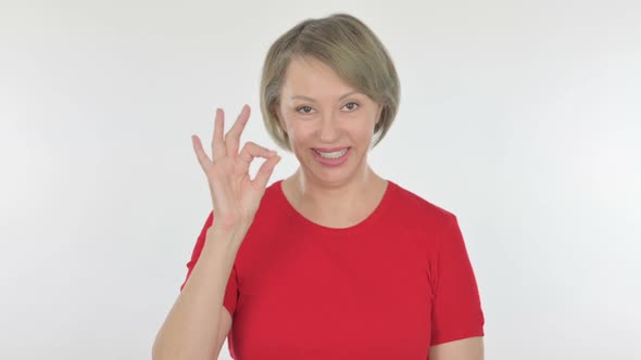 Old Woman with Okay Sign on White Background