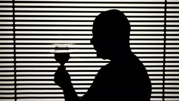 Man Drinking Wine on White Striped Background