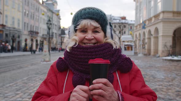 Portrait of Senior Woman Tourist Smiling Looking at Camera in Winter City Center of Lviv Ukraine