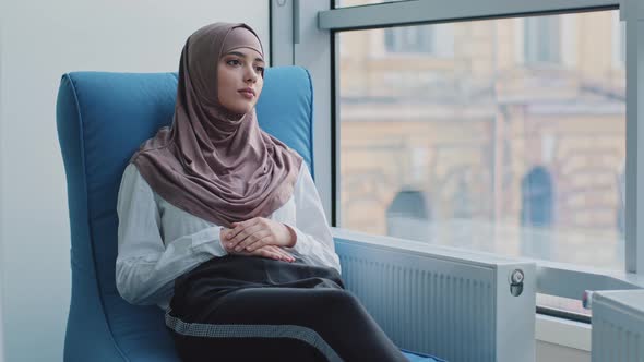 Arabic Female Intern Student in Hijab Waiting for Exam or Interview Results in Armchair