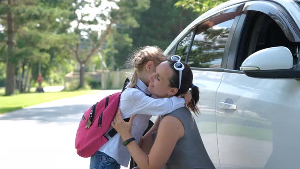 Mother Hugging Daughter Before School Outdoors
