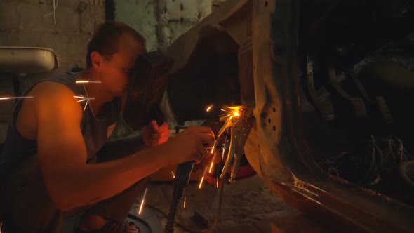 Repairer Wearing Protective Mask Welding Some Detail of Auto