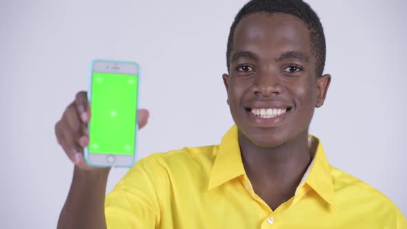 Face of Young Happy African Businessman Showing Phone