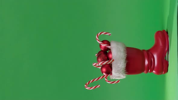 Vertical Video Christmas Scene with Red Boot of Santa Claus