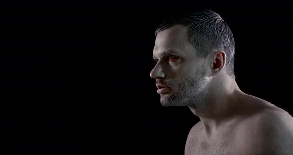 Sorrowful and Pensive Man with White Makeup on Face and Red Inflamed Eyes Is Posing in Black