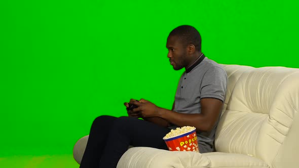 Man Excitedly Playing a Game on the Console and Loses. Green Screen