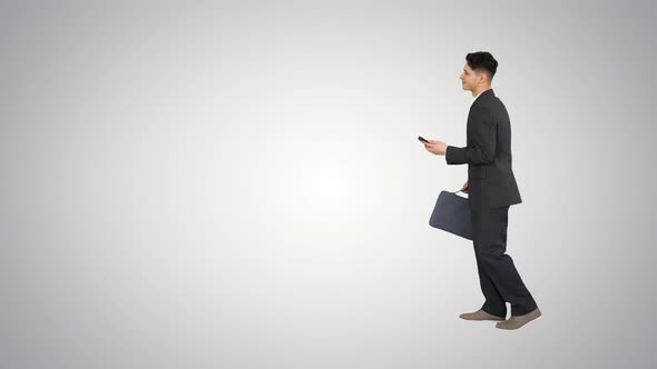 Happy Successful Businessman Dancing Listening Music From the Phone And Walking on Gradient