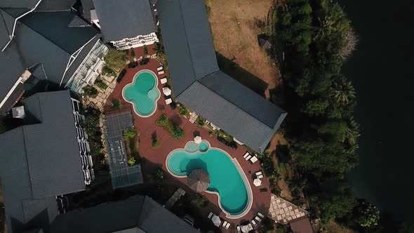 Spinning Aerial View Of Resort With Swimming Pool