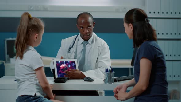 Health Specialist Showing Virus Illustration on Digital Tablet