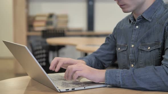 Creative Man Celebrating Success While Working on Laptop