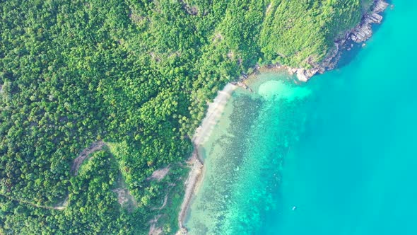 Aerial flying over landscape of tropical seashore beach holiday by blue ocean and white sandy backgr