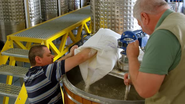 Male workers preparing gin in distillery 4k