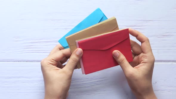 Love Letter in Women Hand on Red Background , Top View.