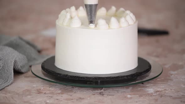 Woman Decorating Whipped Cream on Cake