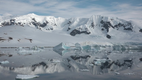 Icebergs are reflected in the water. Antarctic Nature. Majestic winter landscape.