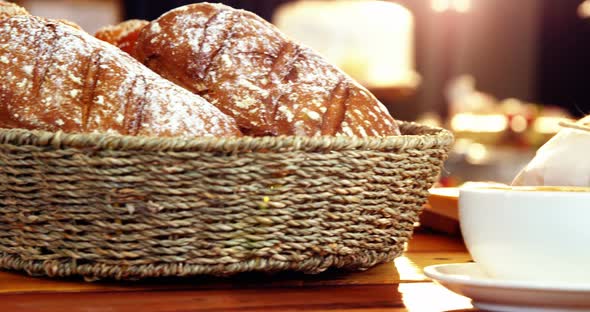 Basket of bread and coffee cup in counter