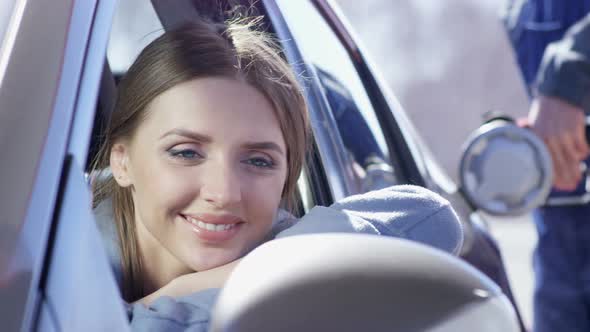 Happy Female Customer at Gas Station