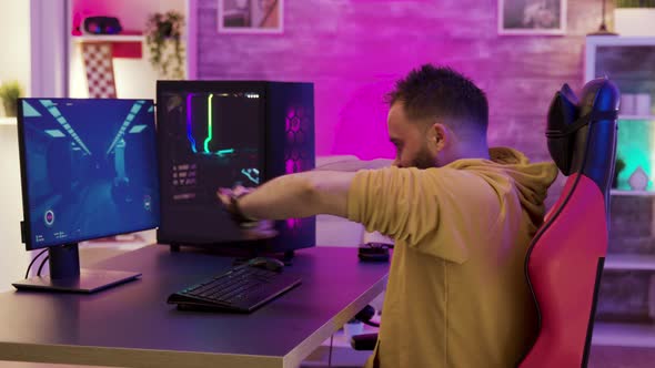 Bearded Man Sitting on Gaming Chair Preparing To Play Video Games