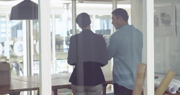 Young man and woman working in a creative office