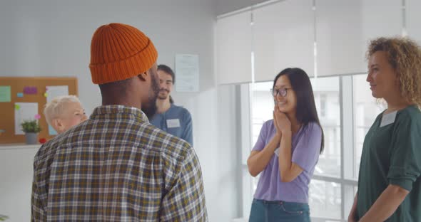 Happy Young Diverse People Hugging Each Other in Support Group Meeting