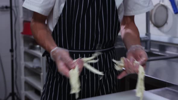 Cheese Factory  Man Worker in Gloves Rips Soft Cheese Into Pieces