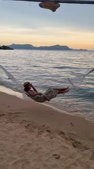 Women in a Hammock on the Beach in Pattaya During Sunset in Thailand Ban Amphur Beach