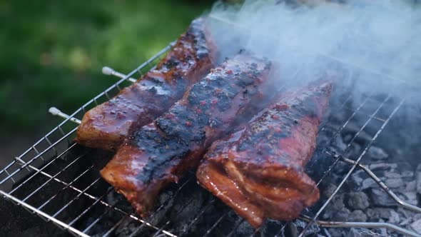 Delicious Beef or Pork Ribs Frying on a Charcoal Grill