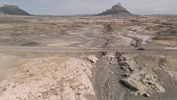 Aerial view of vehicle driving on muddy road after flood in the Utah desert