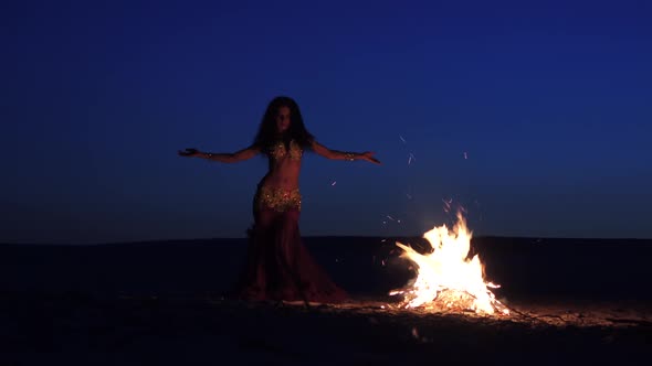 Dancer in Special Clothes Is Dancing Belly Dancing, Near the Fire