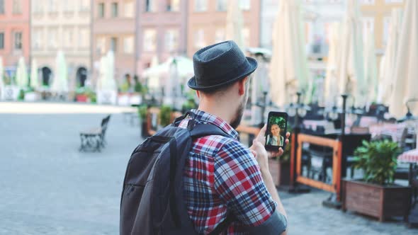 Tourist Making Video Call on Smartphone with Female Tourist From Other Place