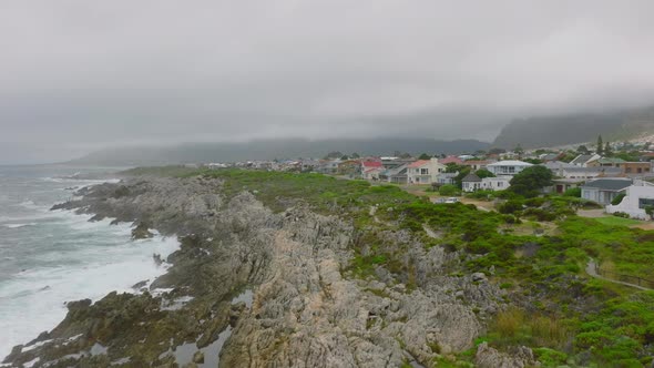 Aerial View of Sea Waves Crashing to Jagged Coastal Rocks