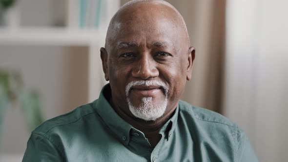 Male Headshot at Home Calm Elderly Senior Adult African 60s Man Friendly Face Sit Indoors Looking at