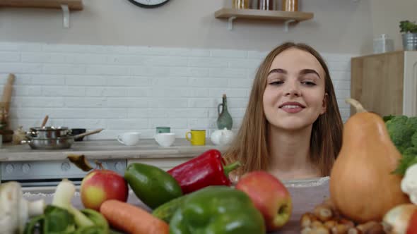 Lovely Young Girl Spying From Under the Table and Grabbing Fresh Apple and Eating It. Diet Concept