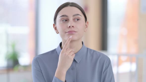 Portrait of Pensive Young Latin Woman Thinking